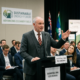 Man in suit speaking at a podium labeled Biodiesel B50 Testimonial at Sustainable Energy Forum